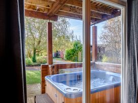 A hot tub with an outdoor view at Birch Waterside Spa (Pet) Carlton Miniott near Thirsk