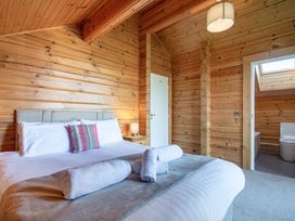 A bedroom with a bed and towels at Birch Waterside Spa (Pet) Carlton Miniott near Thirsk