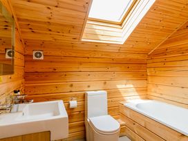 A bathroom with wooden walls and fixtures at Birch Waterside Spa (Pet) Carlton Miniott near Thirsk