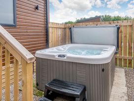 A hot tub with steps outside at Cedar Spa (Pet) Carlton Miniott near Thirsk