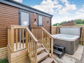An outdoor area with a hot tub and staircase at Cedar Spa (Pet) Carlton Miniott near Thirsk