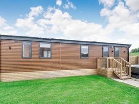 A wooden structure with steps and windows at Cedar Spa (Pet) Carlton Miniott near Thirsk