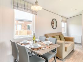 A dining area with a table set for meals at Cedar Spa (Pet) Carlton Miniott near Thirsk
