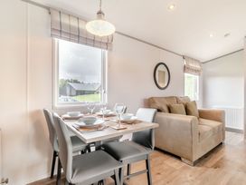 A dining room with a table set for meals at Kinder Spa (Pet) Carlton Miniott near Thirsk