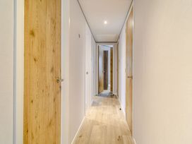 A hallway with wooden doors and flooring at Oak Waterside Spa in Carlton Miniott near Thirsk