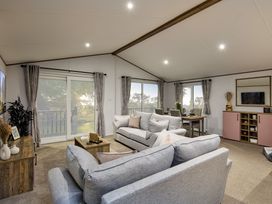 A living room with a sofa and dining table at Laurel Spa Carlton Miniott near Thirsk