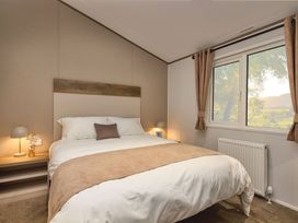 A bedroom with a bed and window at Laurel Spa Carlton Miniott near Thirsk