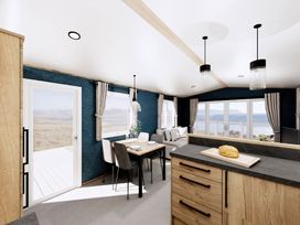 A kitchen with a dining table and sofa at Willow Spa (Pet) Carlton Miniott near Thirsk