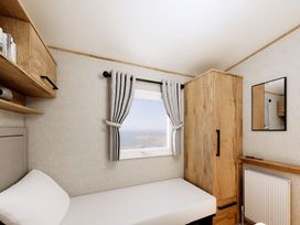 A bedroom with a bed and window at Willow Spa (Pet) Carlton Miniott near Thirsk