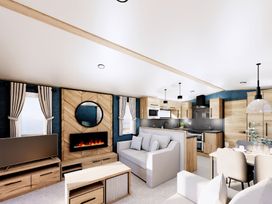 A living room with a sofa and dining table at Willow Waterside Spa Carlton Miniott near Thirsk