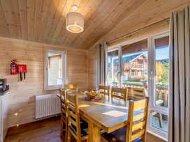 A dining room with a table and chairs at Fir Tree Waterside Spa in Carlton Miniott near Thirsk