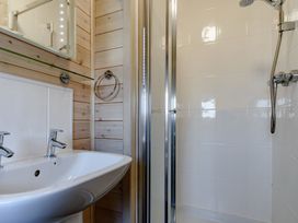 A bathroom with a sink and shower at Fir Tree Waterside Spa Carlton Miniott near Thirsk