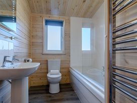 A bathroom with a sink, toilet and bathtub at Fir Tree Waterside Spa Carlton Miniott near Thirsk