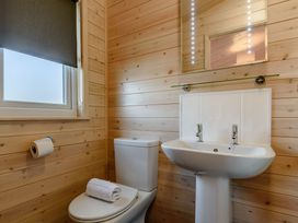 A bathroom with sink and toilet at Fir Tree Waterside Spa Carlton Miniott near Thirsk