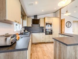 A kitchen with cabinets and appliances at Spindle Spa (Pet) Carlton Miniott near Thirsk