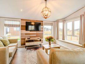 A living room with a television and sofa at Spindle Spa (Pet) Carlton Miniott near Thirsk