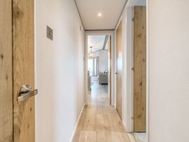 A hallway with doors on both sides at Spindle Spa (Pet) Carlton Miniott near Thirsk