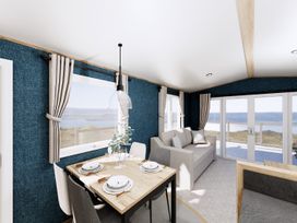 A dining room with a table and chairs at Oak Spa (Pet) Carlton Miniott near Thirsk