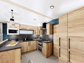 A kitchen with cabinets and appliances at Oak Spa (Pet) Carlton Miniott near Thirsk