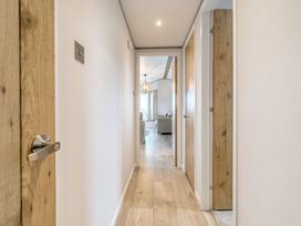 A hallway with doors leading to rooms at Oak Waterside Spa (Pet) Carlton Miniott near Thirsk