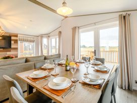 A dining room with a table set for meals at Beech Waterside Spa Carlton Miniott near Thirsk