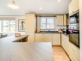 A kitchen with appliances including a sink and oven at Beech Waterside Spa Carlton Miniott near Thirsk