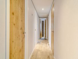 A hallway with wooden doors and wooden floor at Beech Waterside Spa Carlton Miniott near Thirsk