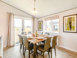 A dining room with a table set for dinner at Beech Waterside Spa (Pet) Carlton Miniott near Thirsk
