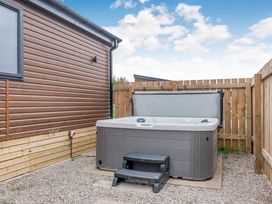 An outdoor area with a hot tub and steps at Beech Waterside Spa (Pet) Carlton Miniott near Thirsk