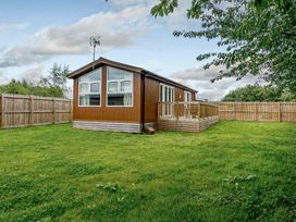A house with a deck and fenced yard at Cherry Tree in Carlton Miniott near Thirsk