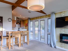 A kitchen with a breakfast bar and appliances at Cherry Tree Carlton Miniott near Thirsk