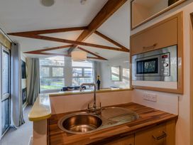 A kitchen with a sink and microwave at Cherry Tree Carlton Miniott near Thirsk