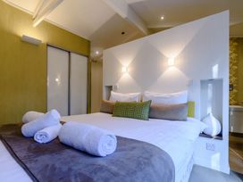 A bedroom with a bed and towels at Cherry Tree in Carlton Miniott near Thirsk