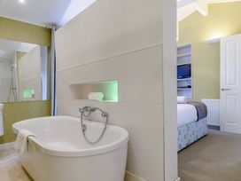 A bathroom with a bathtub and shower at Cherry Tree in Carlton Miniott near Thirsk