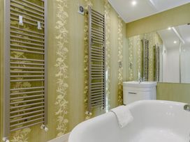 A bathroom with a bathtub and sink at Cherry Tree in Carlton Miniott near Thirsk