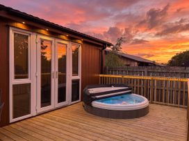 A hot tub on a deck at Cherry Tree Spa Carlton Miniott near Thirsk
