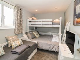 A bedroom with a bunk bed and a double bed at Dunholme