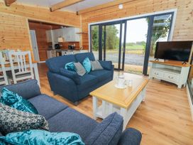 A living room with a sofa and television at Killinure Cottage in Glasson, County Westmeath