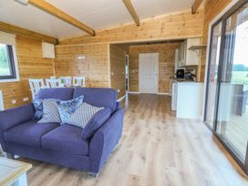 A living room with a sofa and dining area at Killinure Cottage in Glasson, County Westmeath
