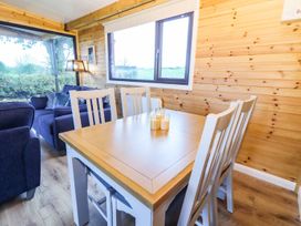 A dining area with a wooden table and chairs at Killinure Cottage in Glasson, County Westmeath