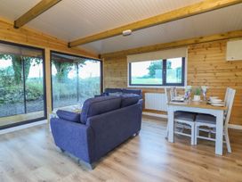 A living room with a sofa and dining table at Killinure Cottage in Glasson, County Westmeath