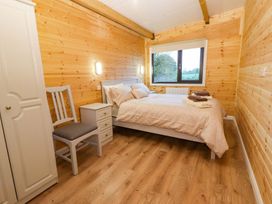 A bedroom with a bed and nightstand at Killinure Cottage in Glasson, County Westmeath