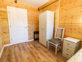 A bedroom with a wardrobe and nightstand at Killinure Cottage Glasson, County Westmeath