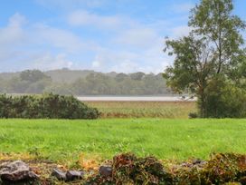 A view of a field and water with trees at Killinure Cottage in Glasson, County Westmeath