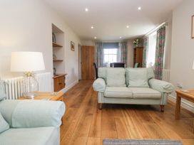 A living room with a sofa and coffee table at Cragg Cottage in Coniston