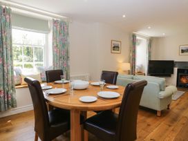 A dining room with a table and chairs at Cragg Cottage Coniston