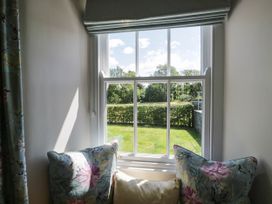 A window with cushions in a sitting room at Cragg Cottage in Coniston