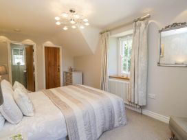 A bedroom with a bed and dresser at Cragg Cottage in Coniston