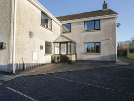 A house exterior with a pathway and planter at Low Greenlands House Tewitfield