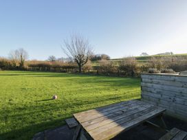 A garden with grass and a bench at Low Greenlands House in Tewitfield